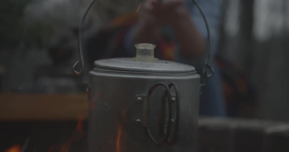A kettle over a burning fire
