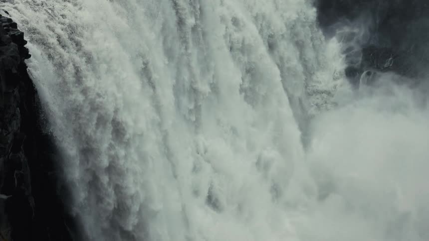Mist rises from the huge waterfall