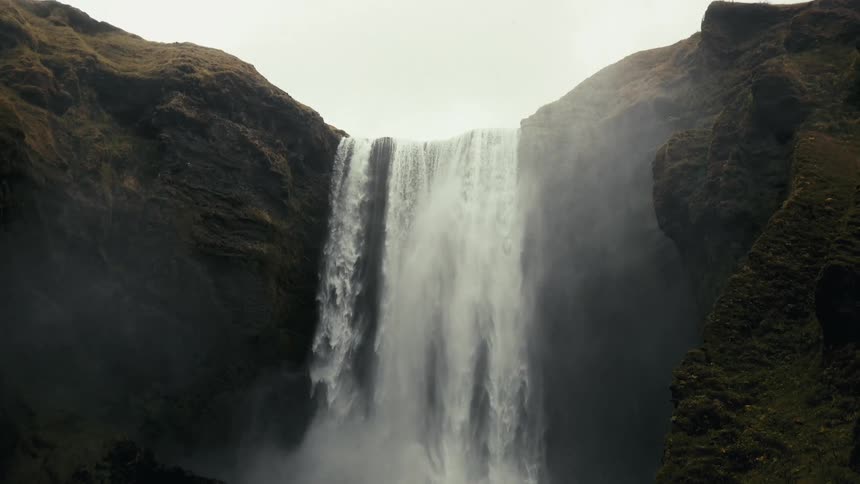 Water falls from a high cliff