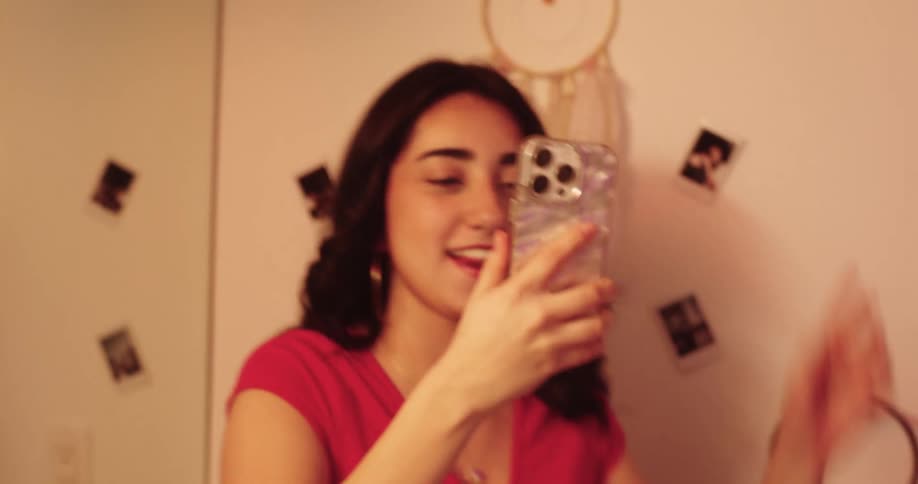 A teenage girl is filming her friends applying makeup in the bathroom