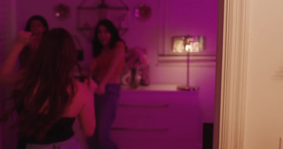 A group of teenage friends have fun dancing in the bedroom
