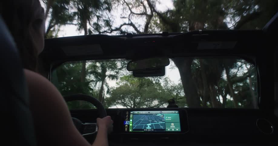 Woman having fun while driving a convertible car