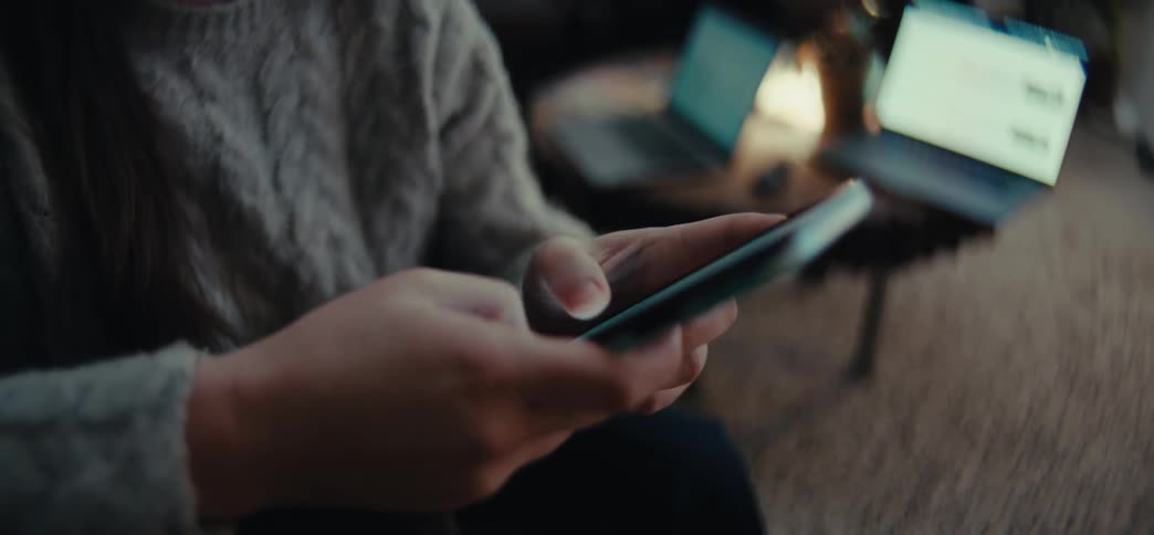 Pair of hands typing on a smartphone