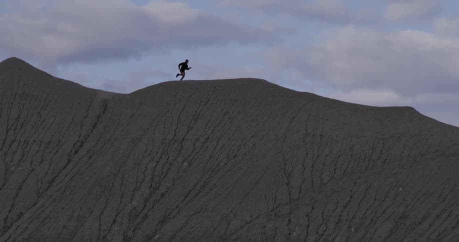 Person running on a mountain cliff