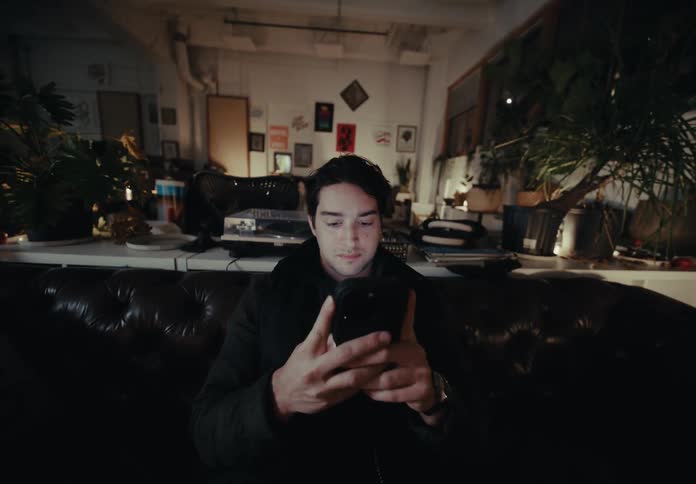 Man sitting typing on smartphone