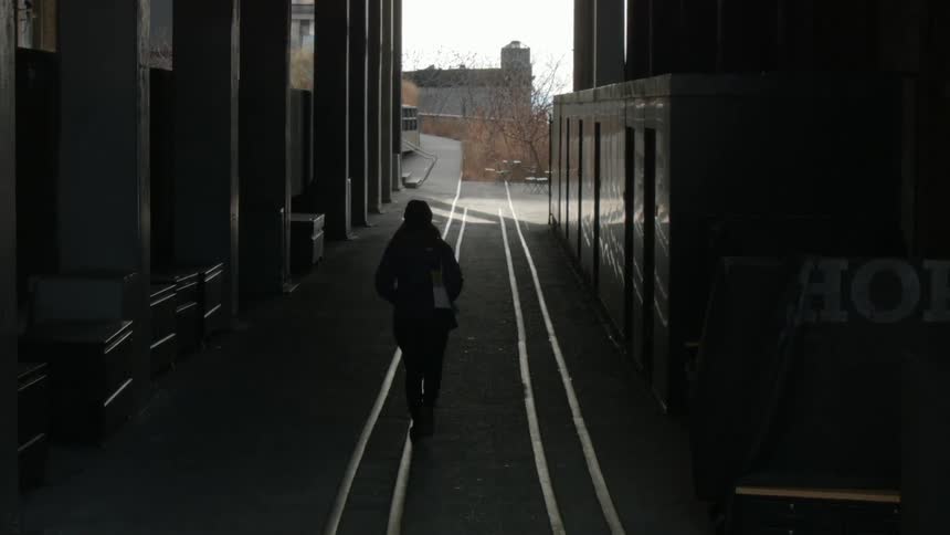 Person walking down an alleyway