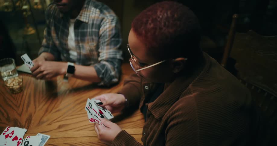 People sitting at a table playing cards