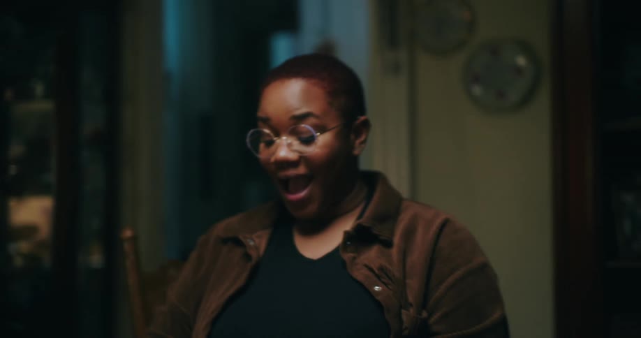 A woman is talking and smiling at home
