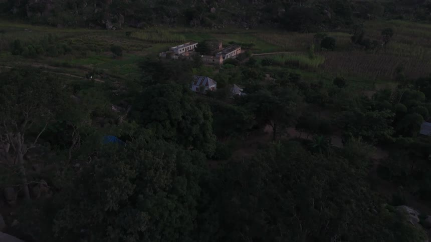 A structure is in the middle of the green landscape