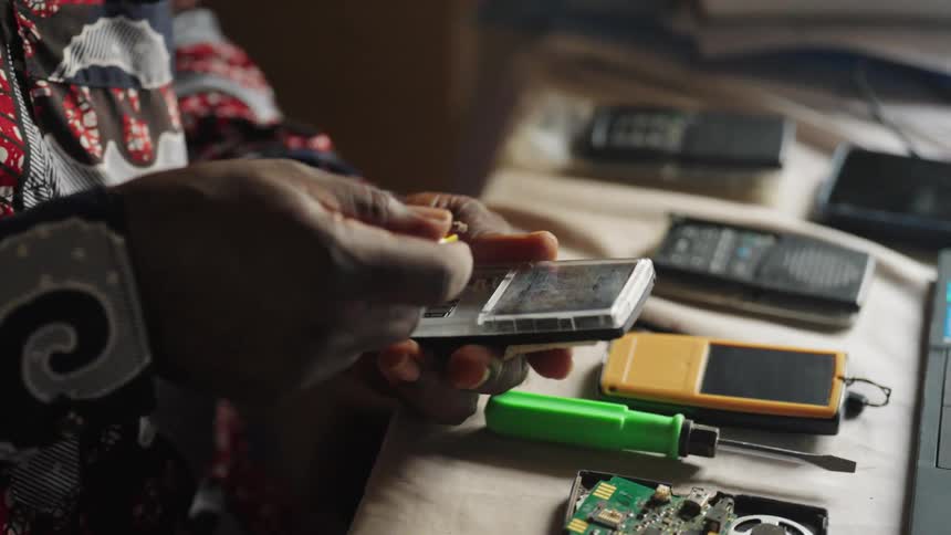 A man is repairing an electronic device