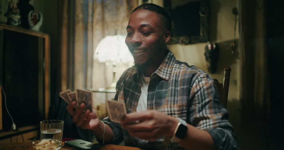 Friends sitting around a table playing cards