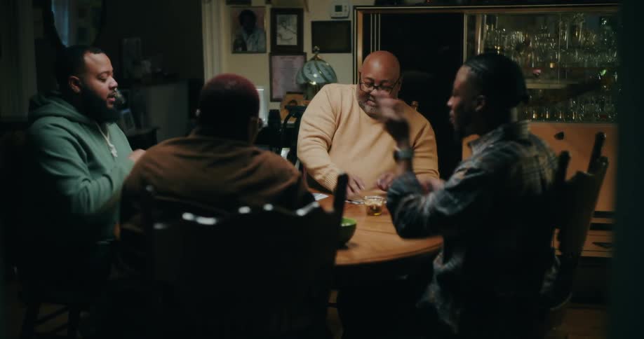 People sitting at a table playing cards