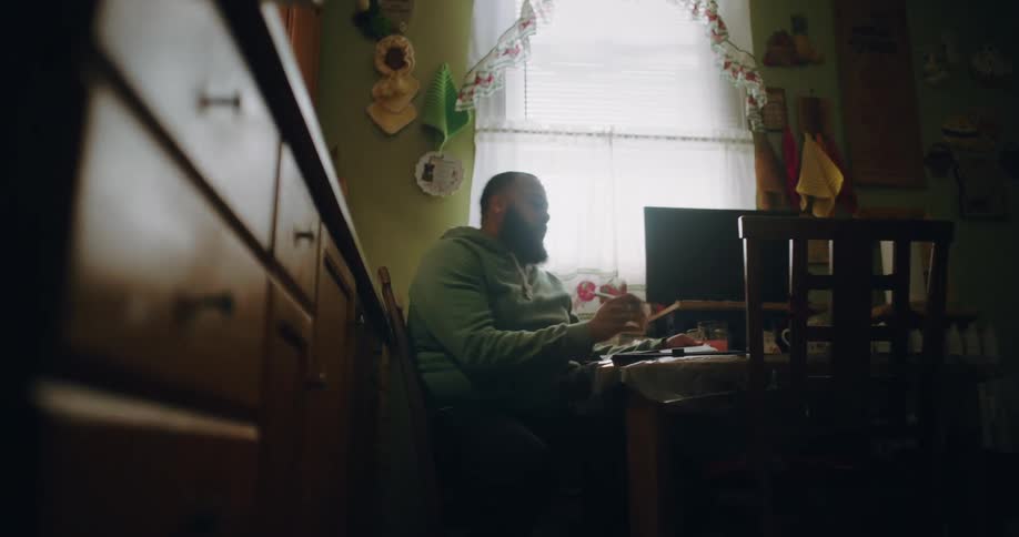 Man sitting at a table holding a pencil