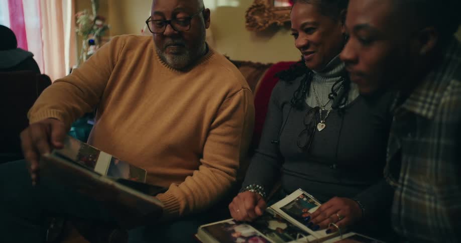 A family flip through pages of a photo album