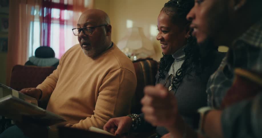 A family talk while looking through photo albums