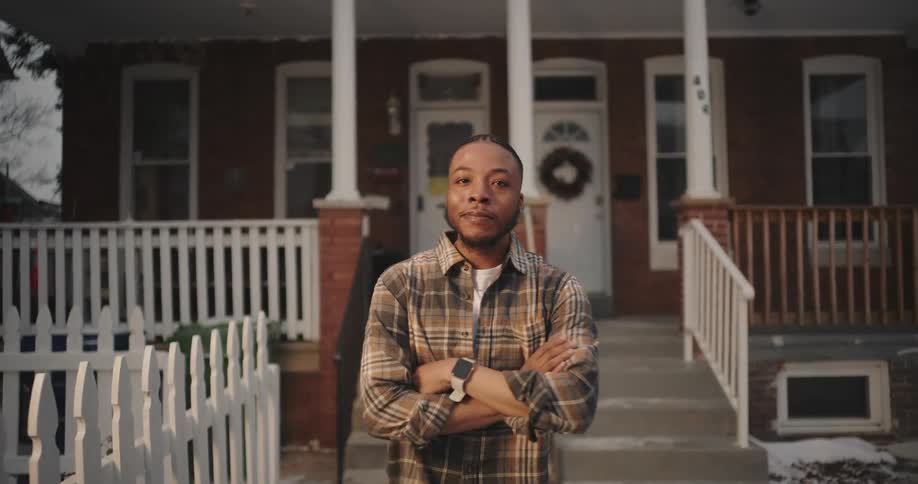 Portrait of a man crossing his arms with a happy facial expression