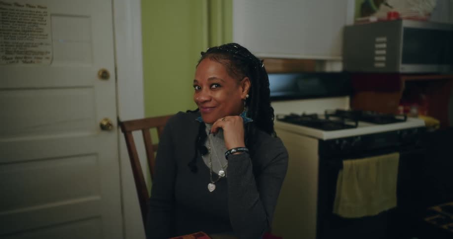 Woman sitting at a table smiling