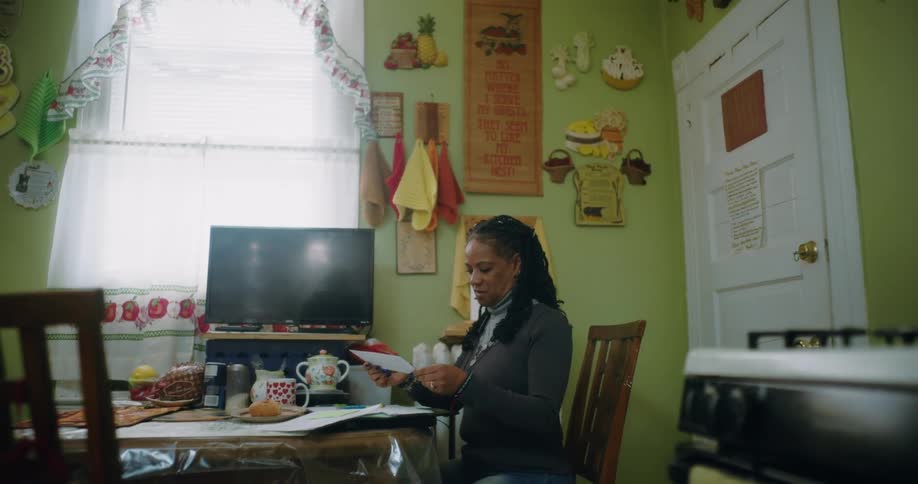 Woman sitting at a table with a notebook in front of her
