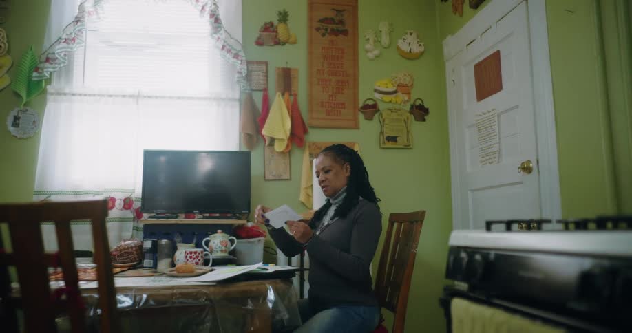 A clip of a sad lady opening a letter