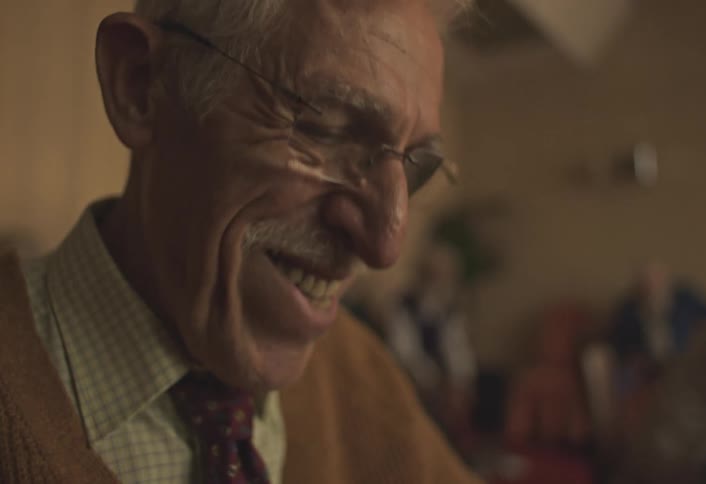 Portrait of an elderly man getting happy
