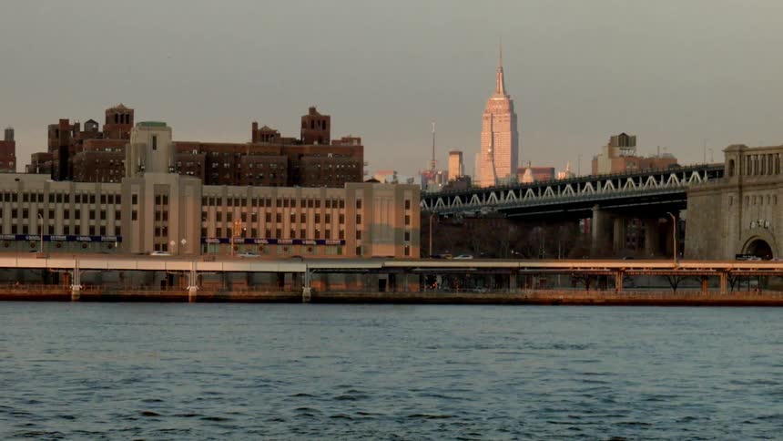 Traffic travels on roadways in a city at dusk