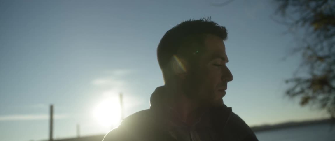 Man looking into distance as the sun sets