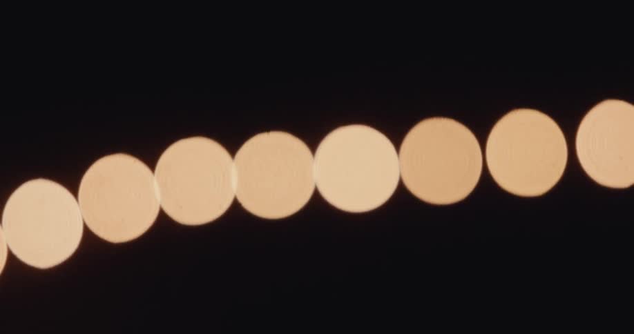 A string of soft lights coming into focus at night