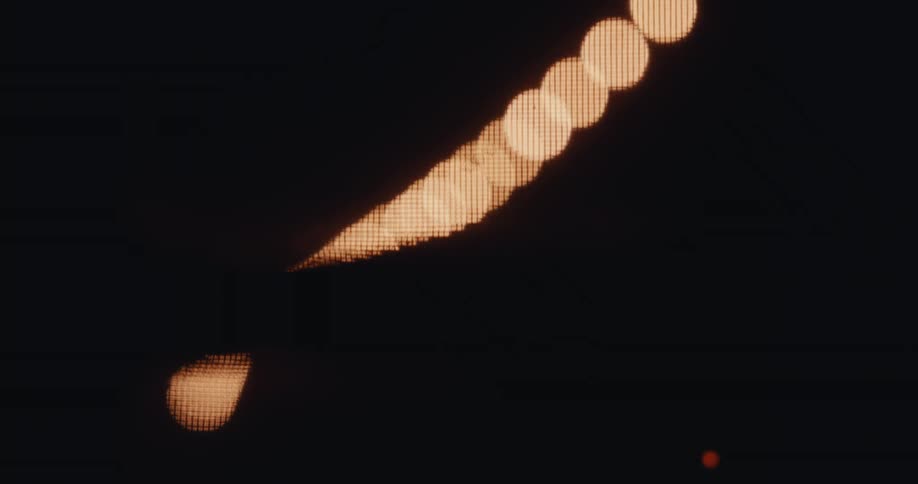 Abstract closeup in blurred light with silhouette of a moving body