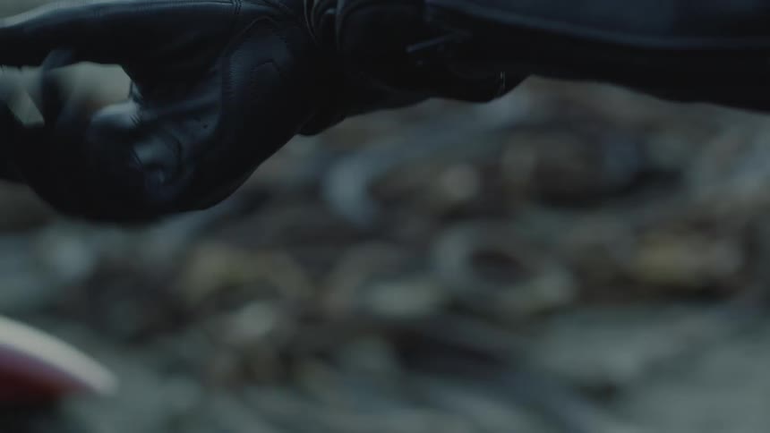 Hand putting on a black leather glove