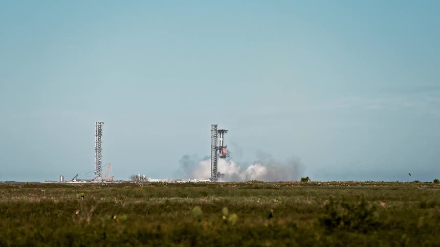 Rocket is in the process of landing releasing smoke against a clear blue sky