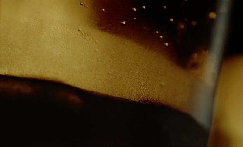 The condensation and bubbles on the inside of a glass with a blurred background