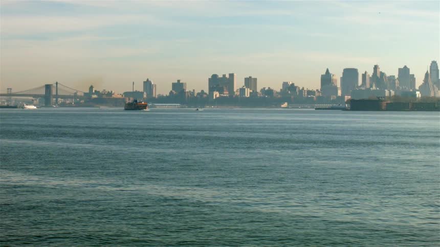 Boats travel in a city harbor