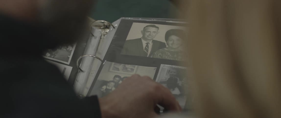 Man and woman flip through a photo album