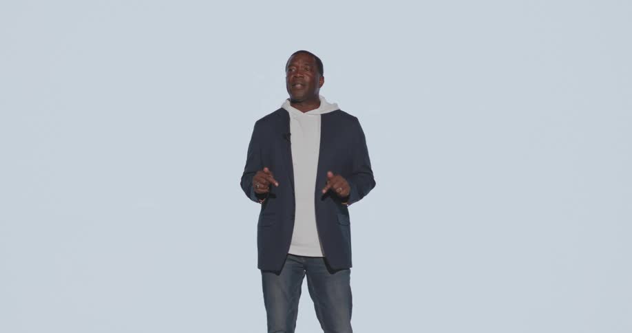 Camera flashes while a man stands giving a speech