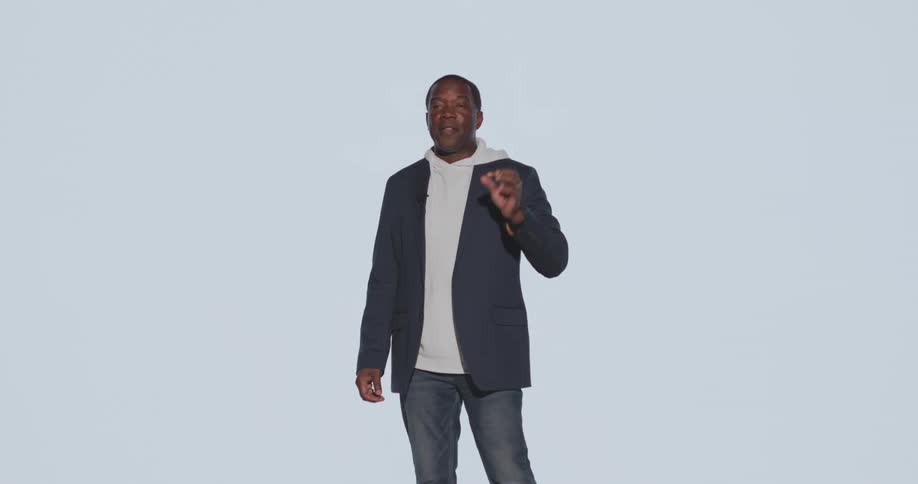 Man standing on a stage giving a lecture