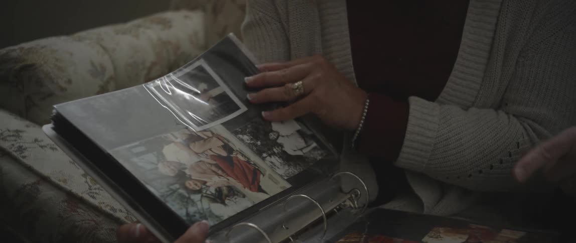 A person looks through an album of photographs