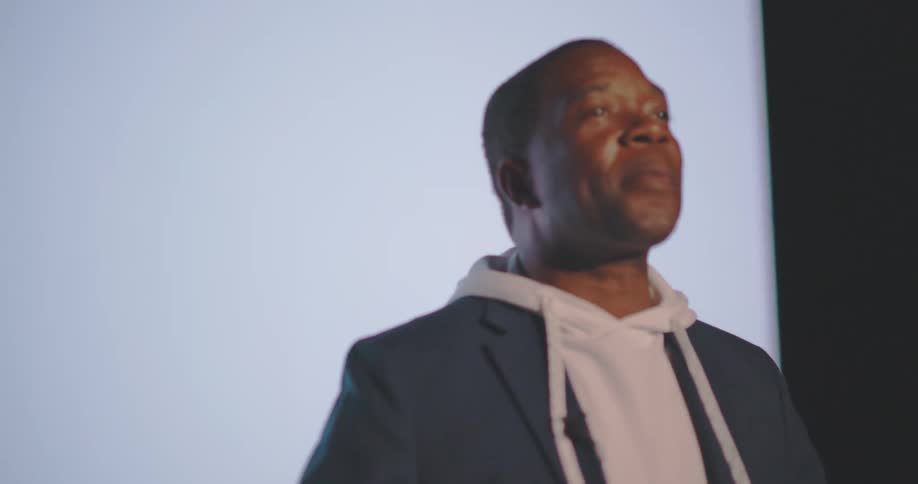 Man speaker receiving multiple flashes