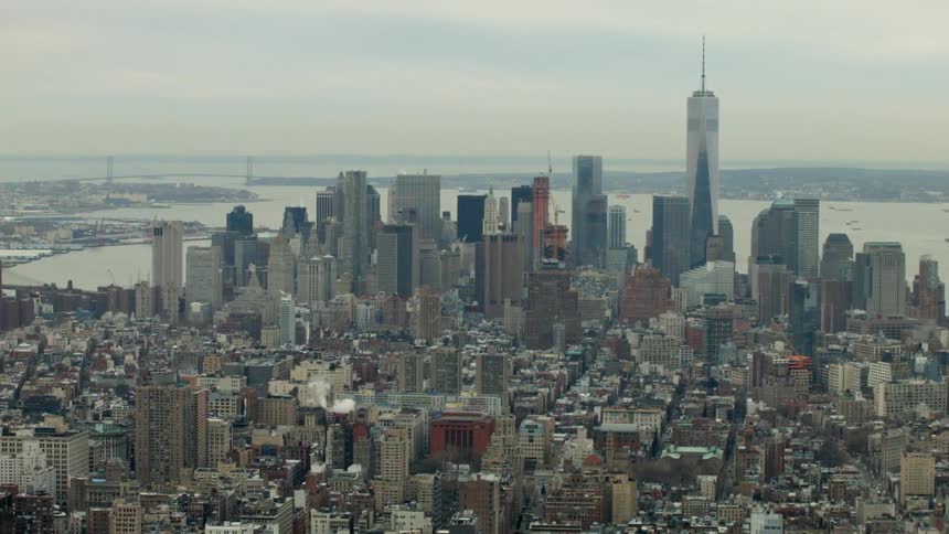 A city on a bay sits beneath a cloudy sky