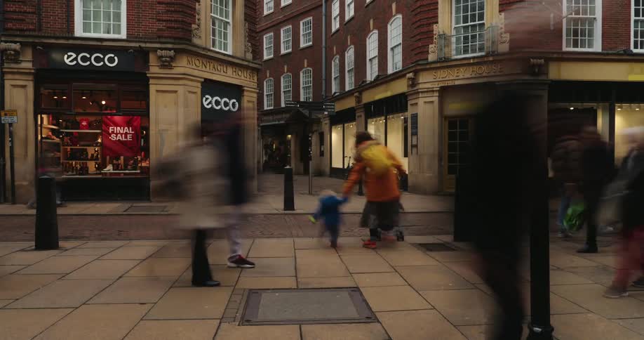 Pedestrians walking on an urban street in a classic city