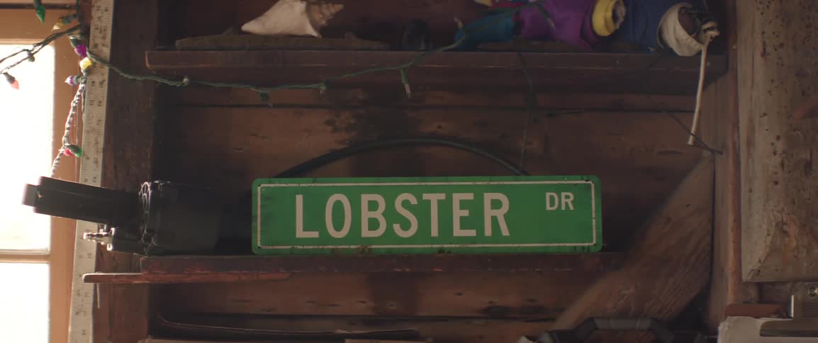 Lobster sign board on a wooden shelf