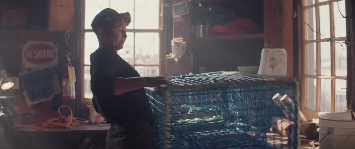 Woman placing a fishing trap on a workbench
