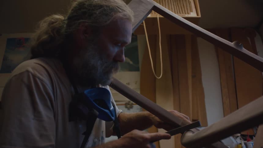 Carpenter sanding a chair