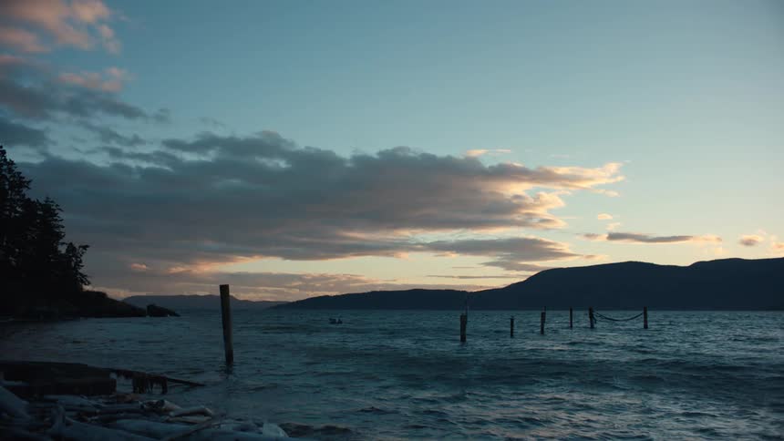 Wooden supports from a long gone pier rise out of the water