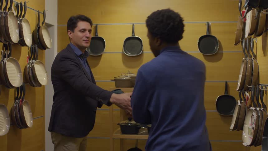 A browsing customer is approached by an employee