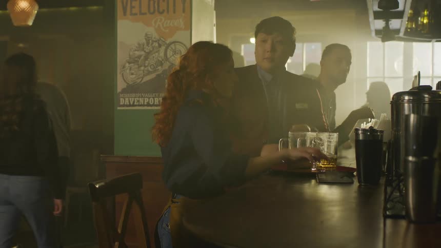 A clip of a waitress receiving instruction in at the bar