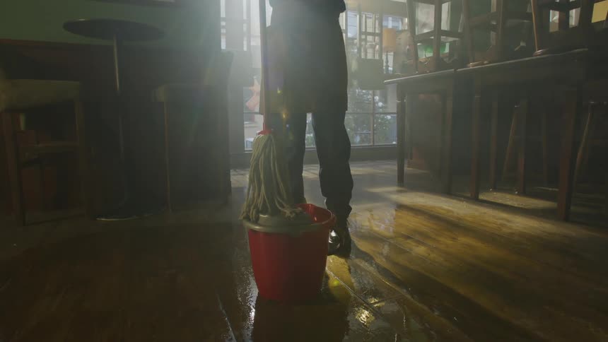 A clip of a lady cleaning the floor