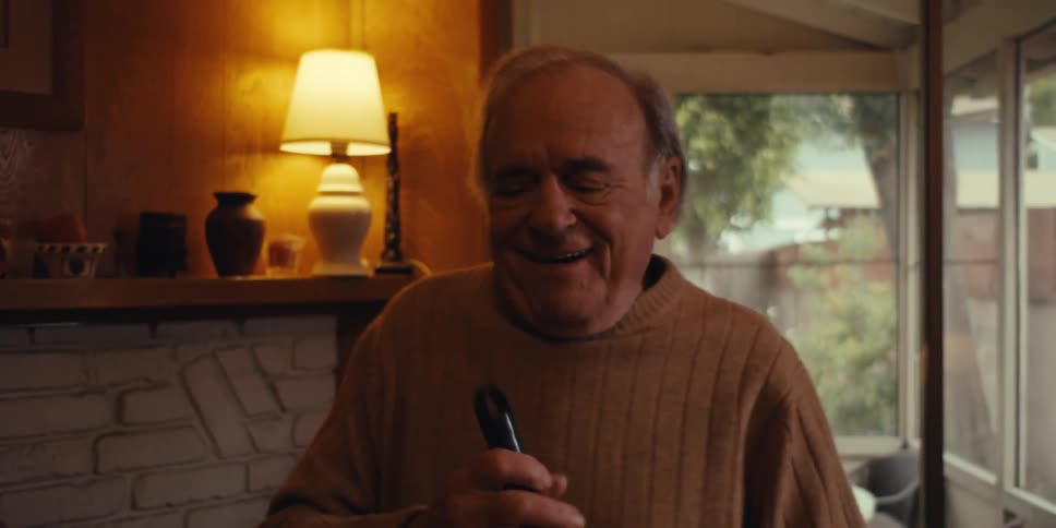 Elderly man dancing while cleaning the living room