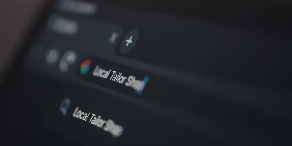 Closeup of an electronic device screen and text being typed into the google browser