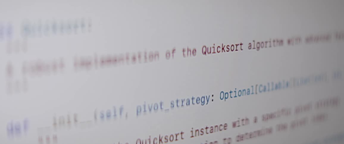 Colored lines of computer code contrast with the white background on a screen