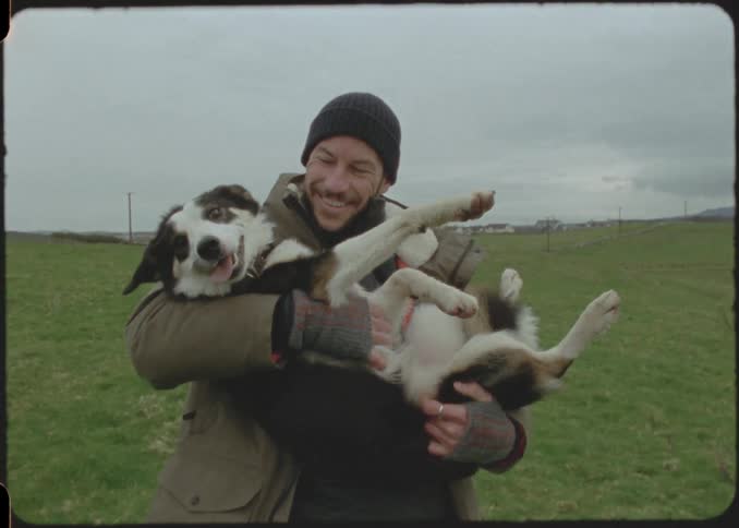 Cheerful man holding his dog like